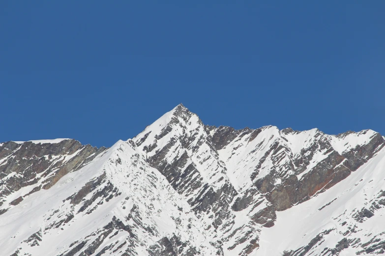 the mountains in the snow look like they could climb