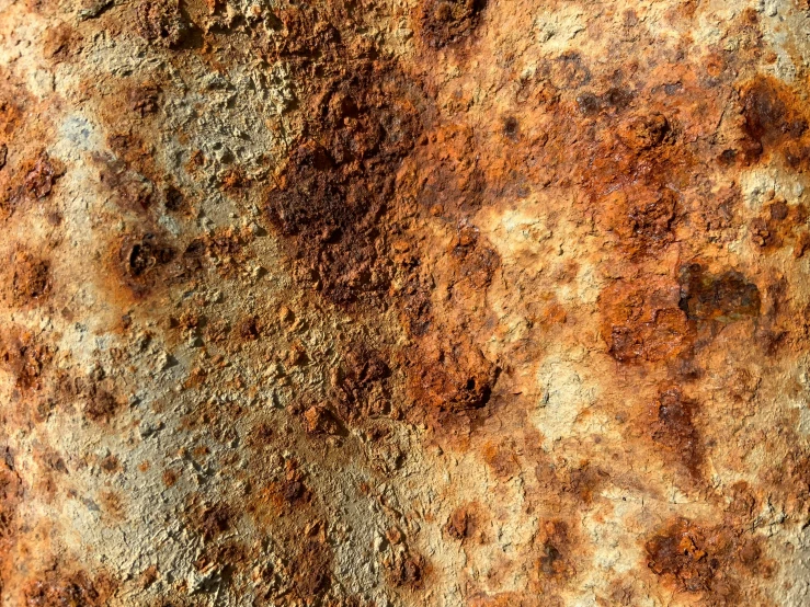 a rusted surface with some dirt and dirt on it