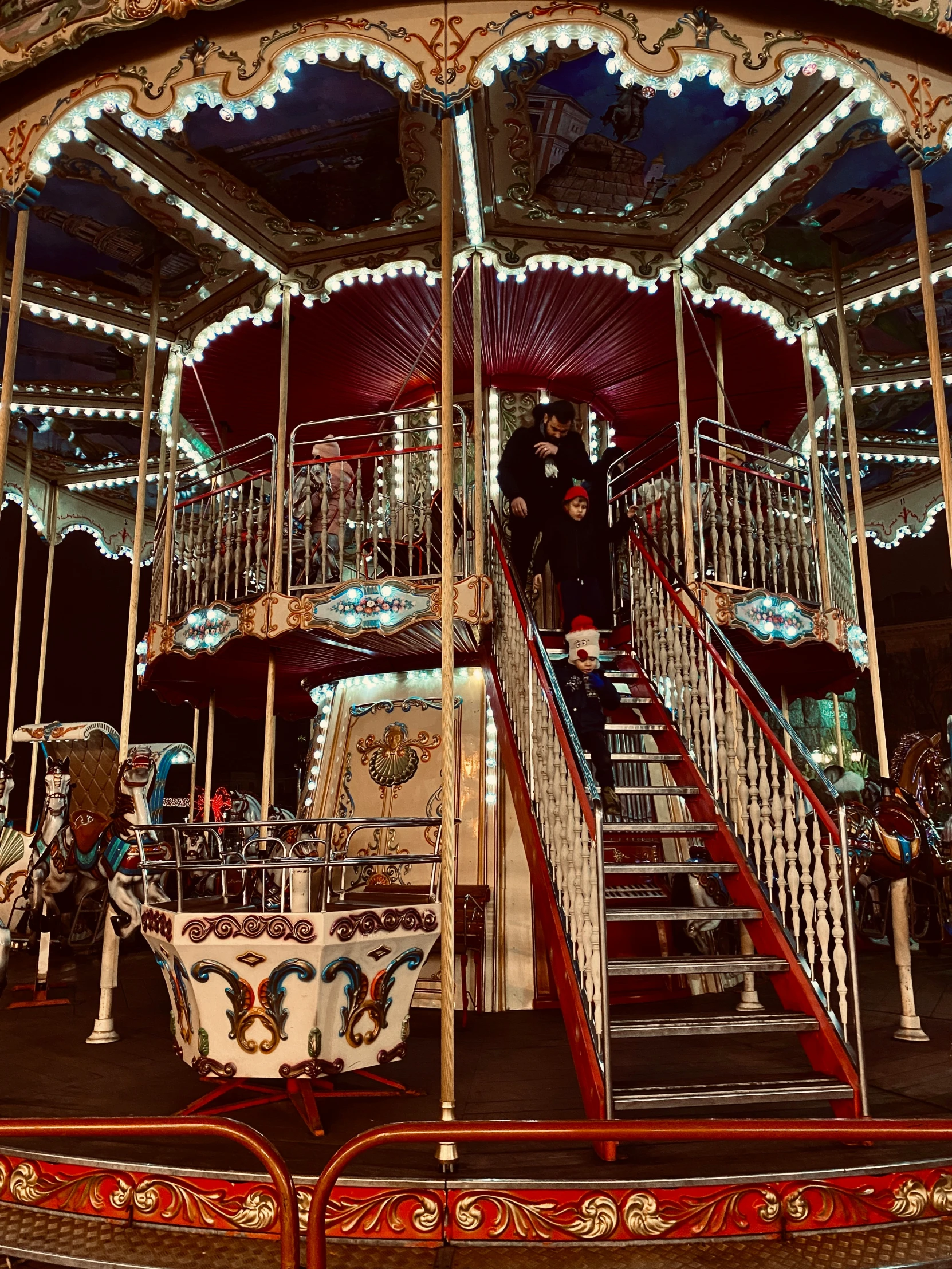 a merry go round with christmas lights and decorations