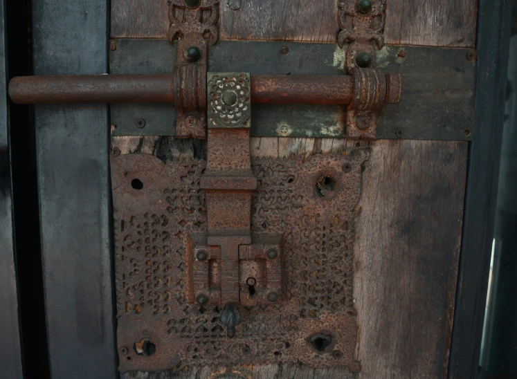 a brown door with rivets and s is open
