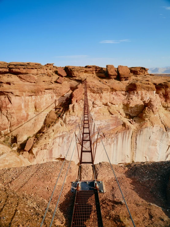 an elevated wooden train track at a quarry near a canyon