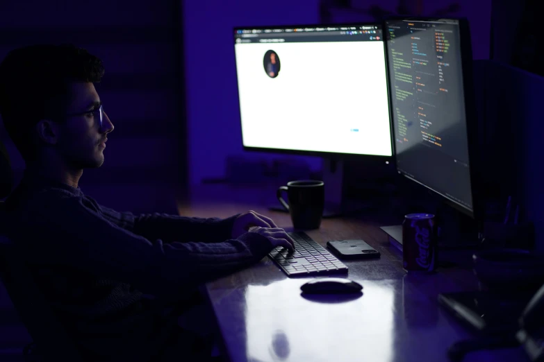 a person is working on their computer at a desk