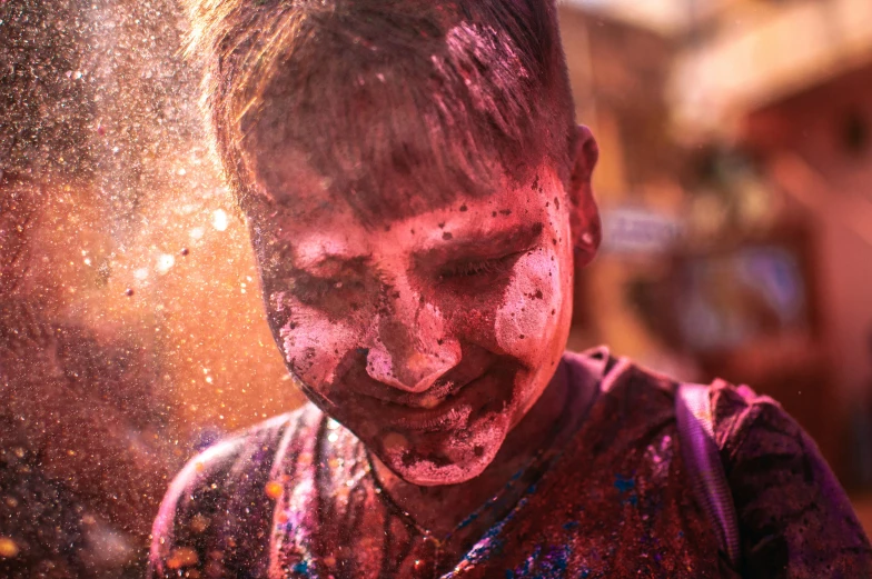 an asian child covered in food, looking down at the ground