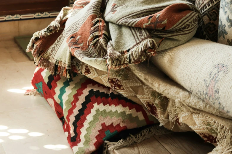 a close up of a pile of blankets sitting on a couch