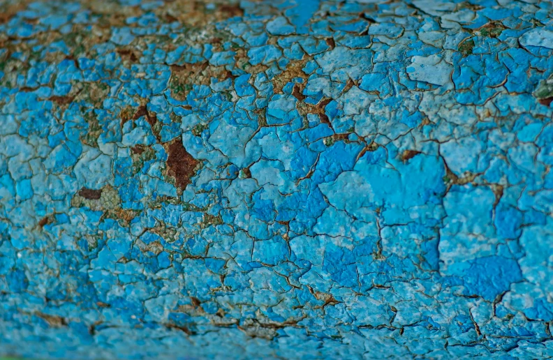 a close up s of blue paint with gold and rust