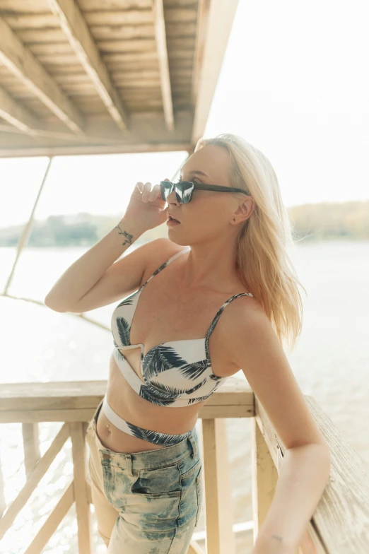 a woman on a pier wearing sun glasses