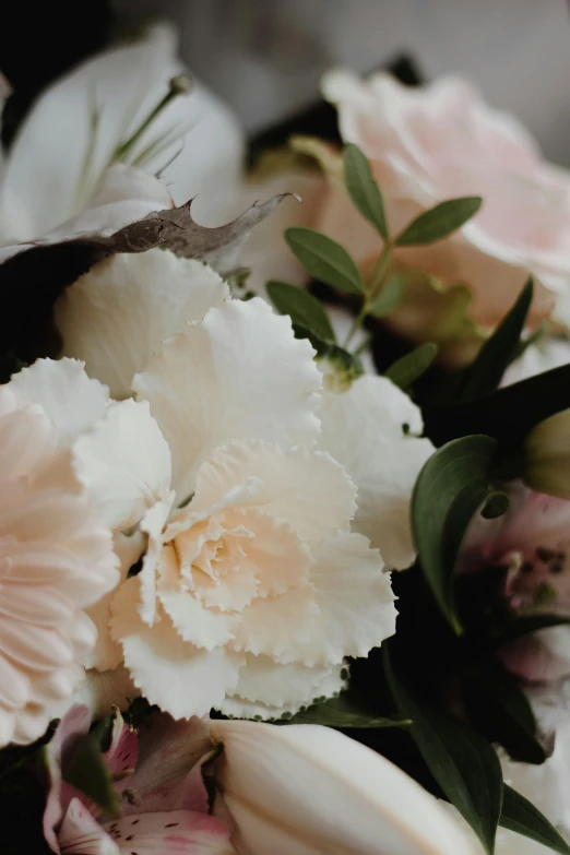 a bunch of flowers are arranged together on a table