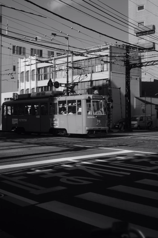 black and white pograph of a trolley and street