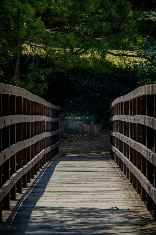 an image of a wooden bridge that is crossing over water