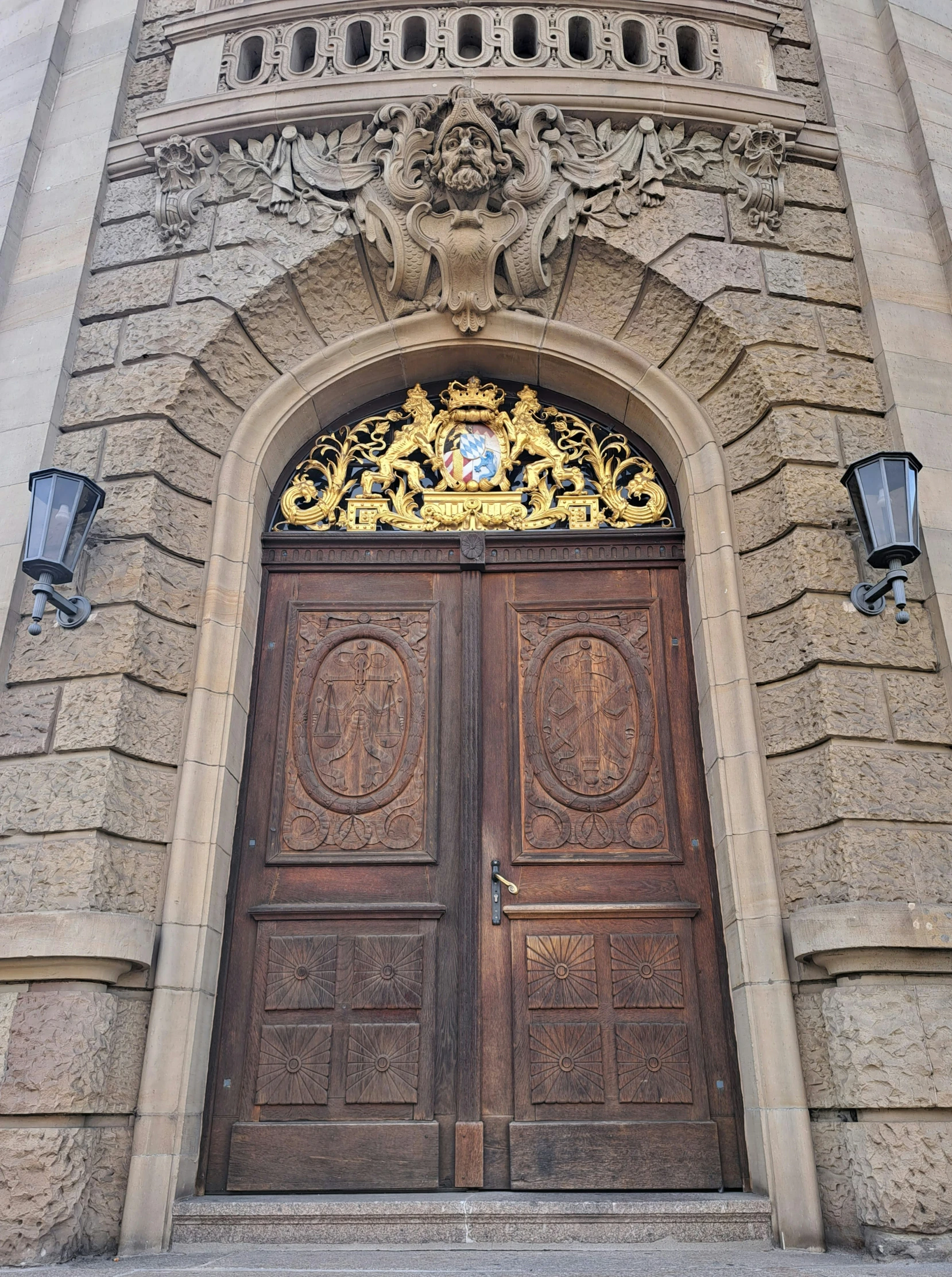 ornate and carved doors of a church near street lights