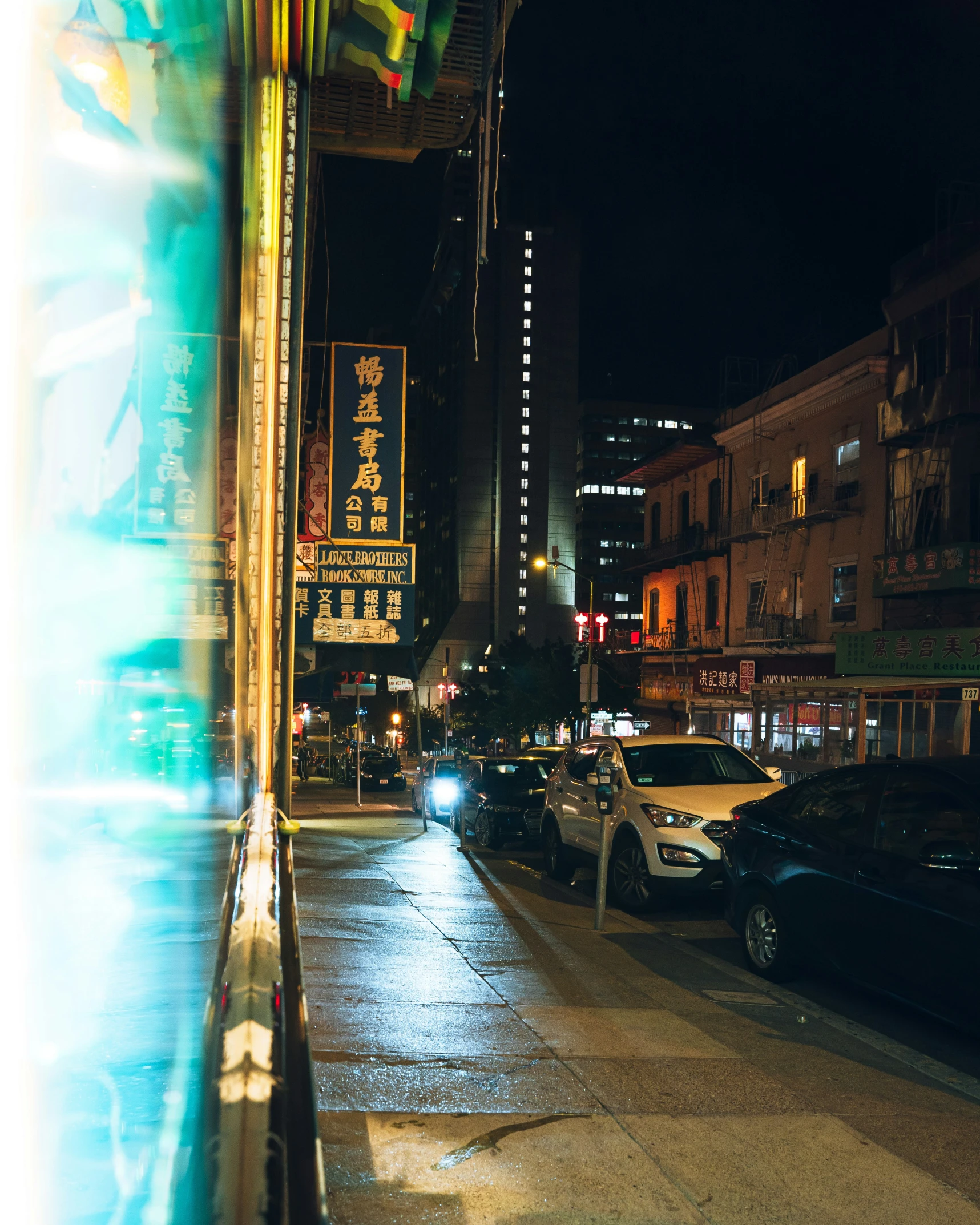 a busy city street with tall buildings at night