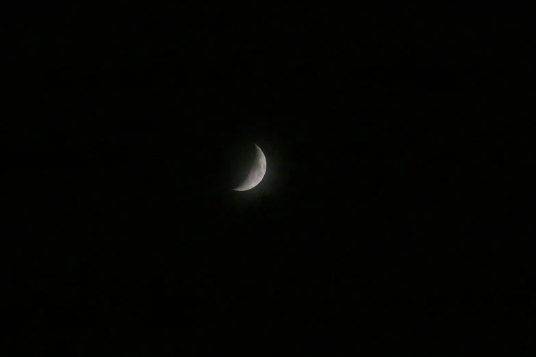 the half moon seen from a distance on black sky