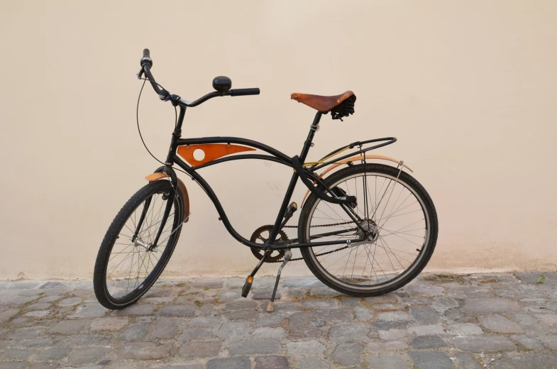 a bike is parked next to a wall