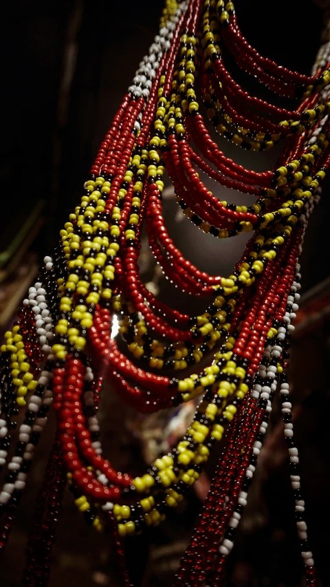 a bunch of beads hanging from a ceiling