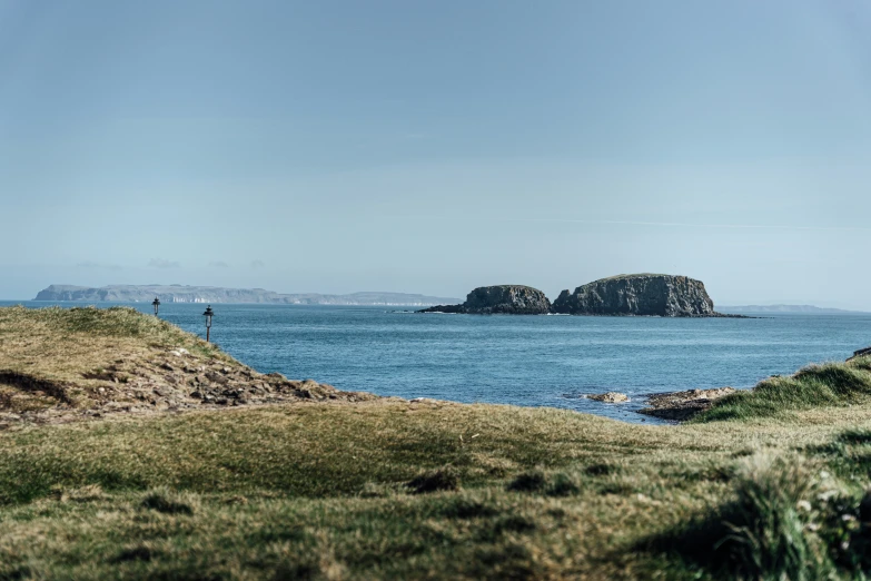 there is some small island on the water near some cliffs