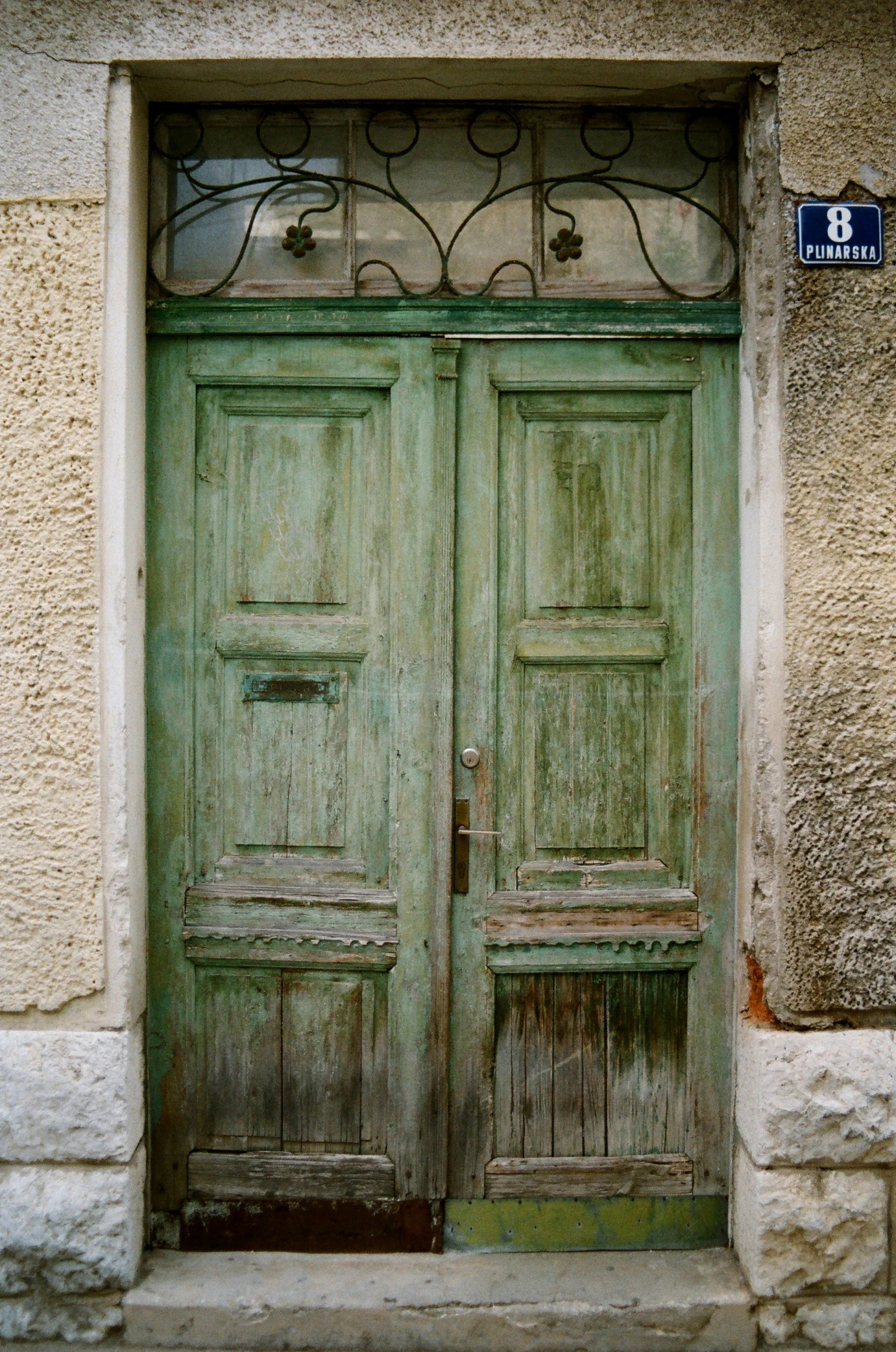 two large wooden doors on a stone building