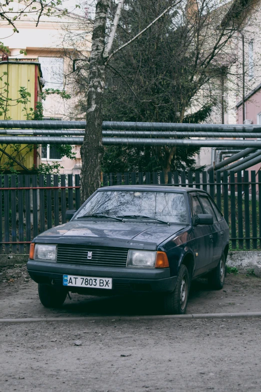 a black car sits parked on the street