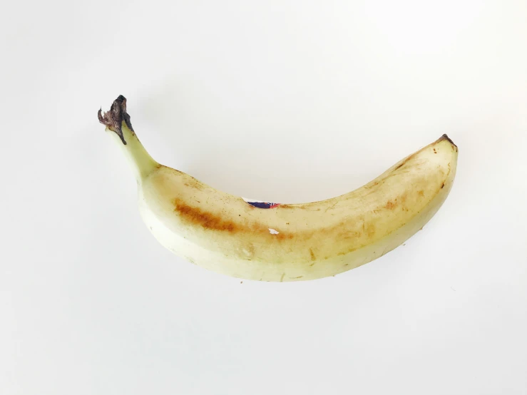 a single banana is seen on a white background