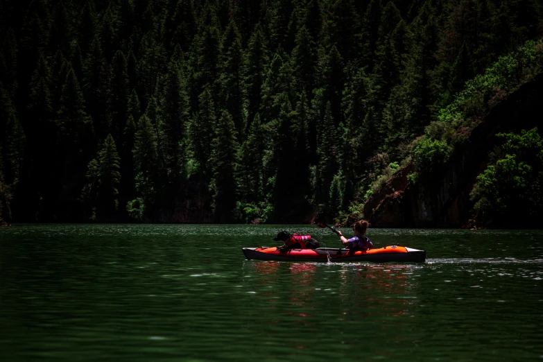 a group of people riding on top of a boat in the middle of water