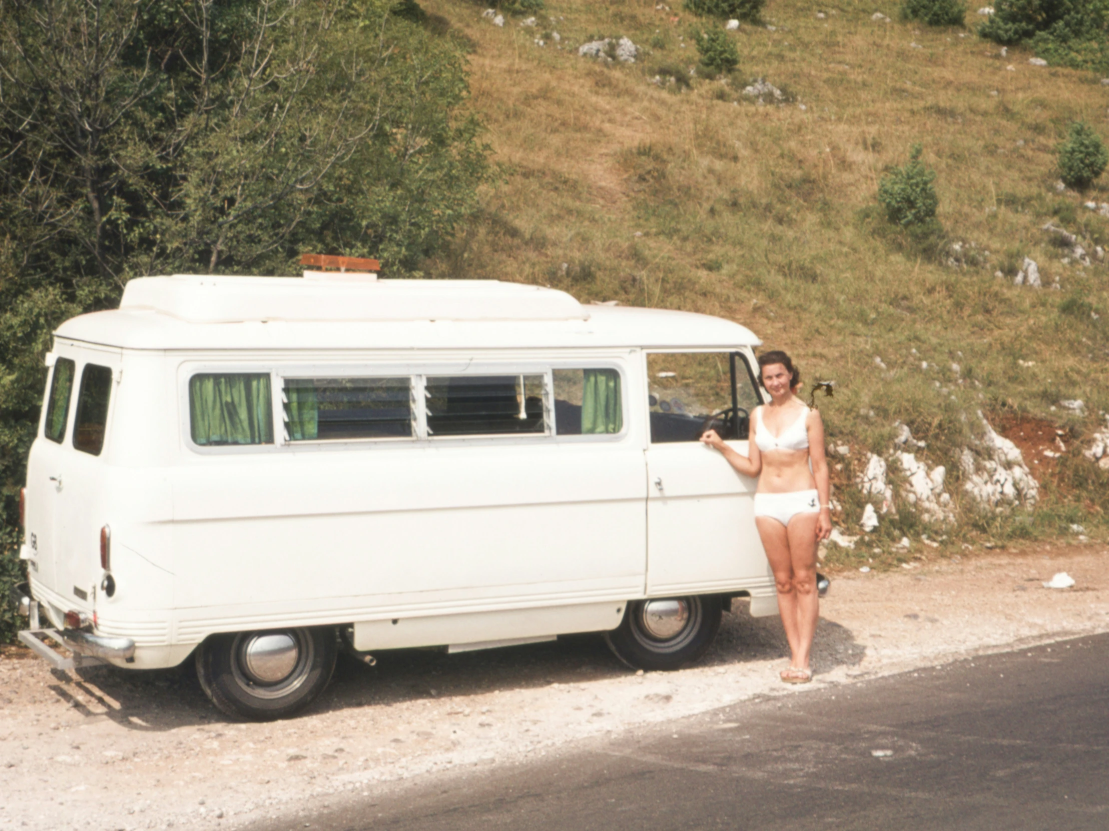 a young lady is standing in front of a van