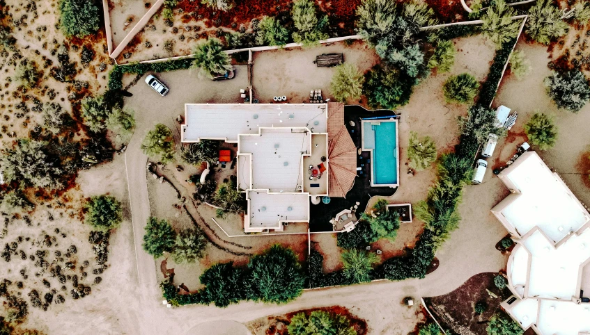 an aerial view of a house in the woods