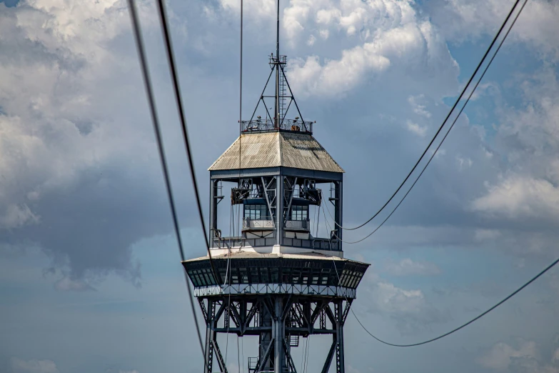 the top of the tower is visible with power lines in foreground