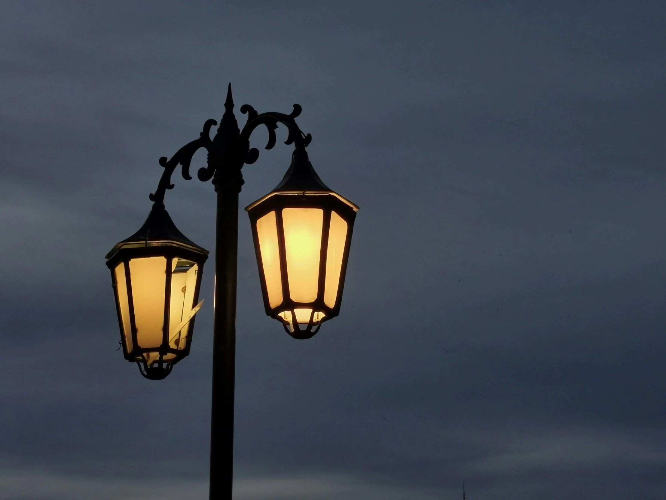 a lamp with two lights on the top and one of them is glowing