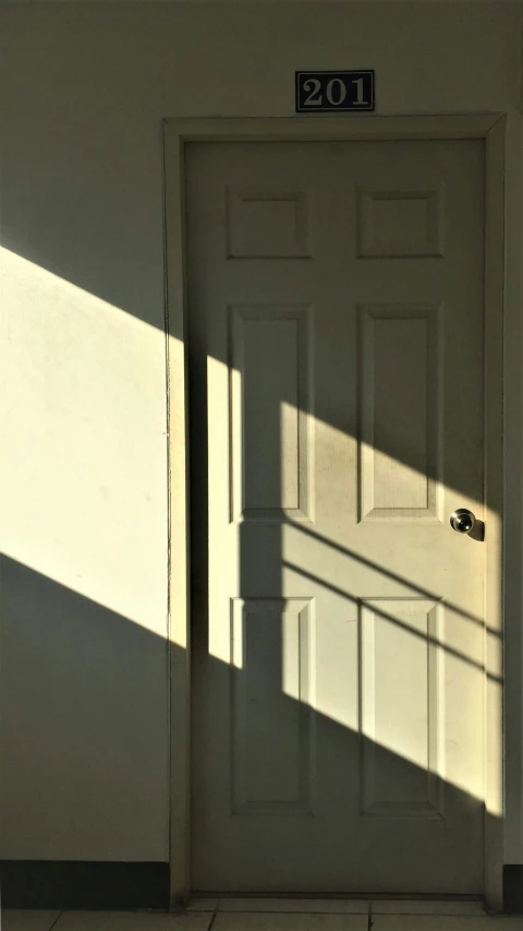 a white door with the light coming through it