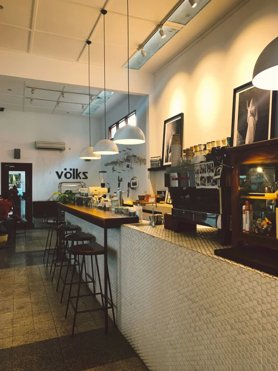 a commercial building with three light fixtures hanging above the bar