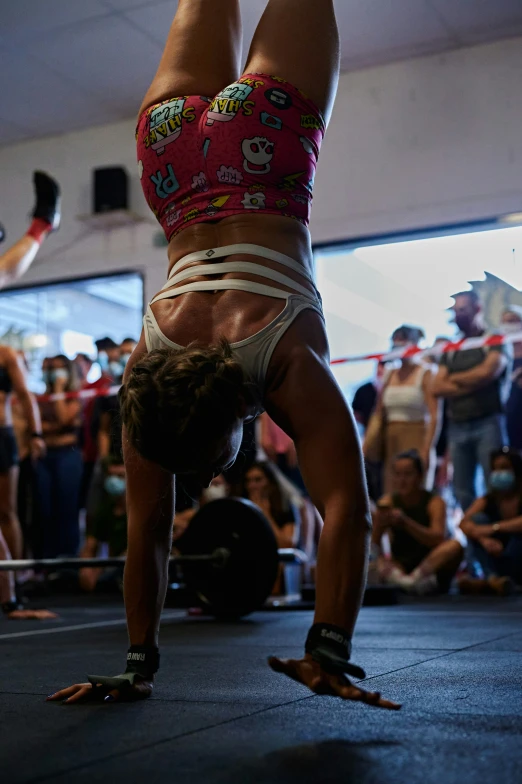 the woman performs a handstand with both legs