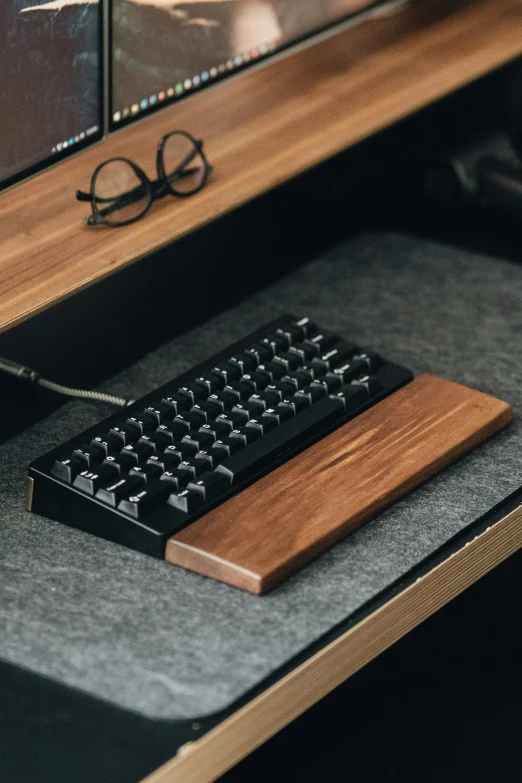 the keyboard and mouse on top of the desk are black