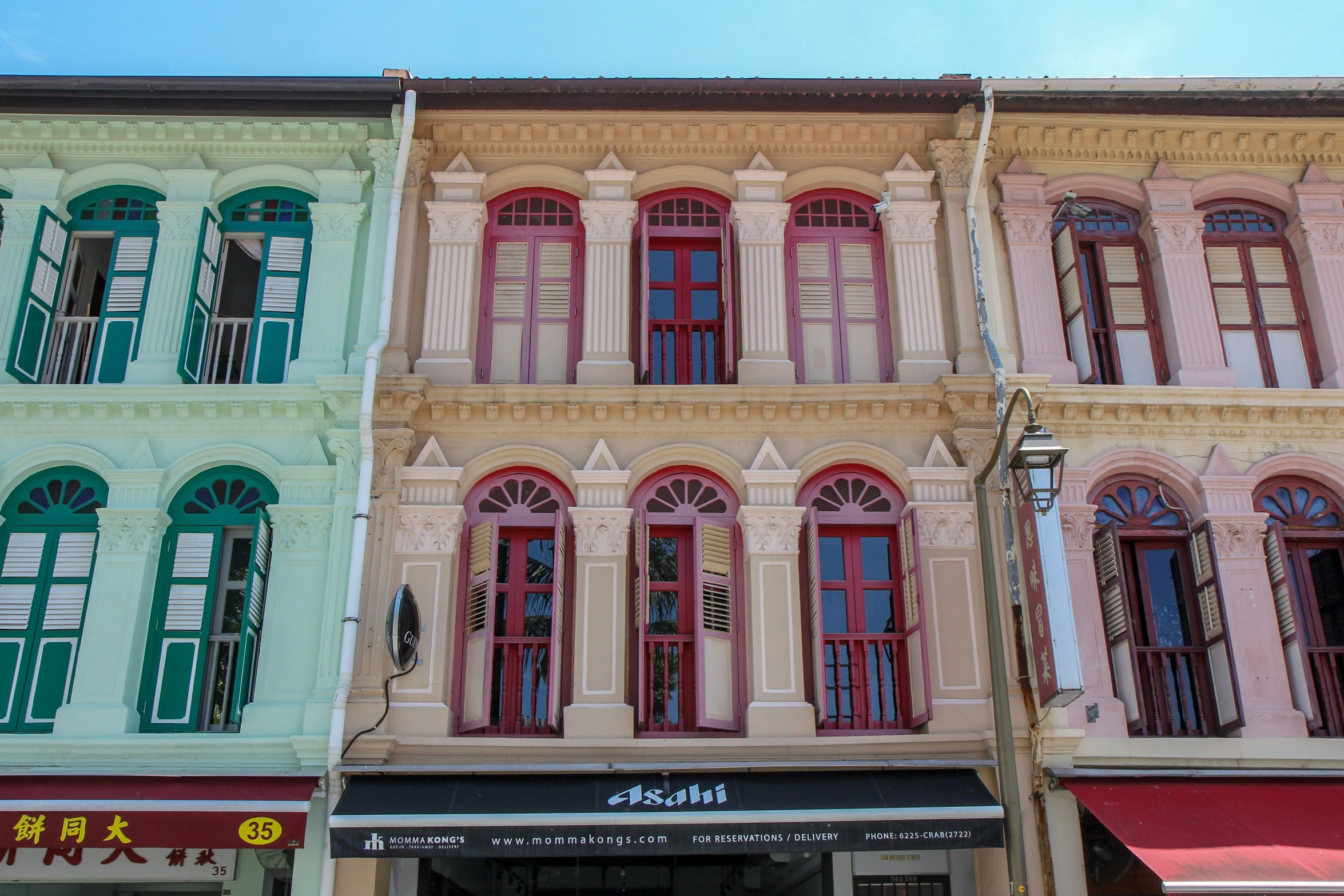 a row of colorful building next to a parking lot