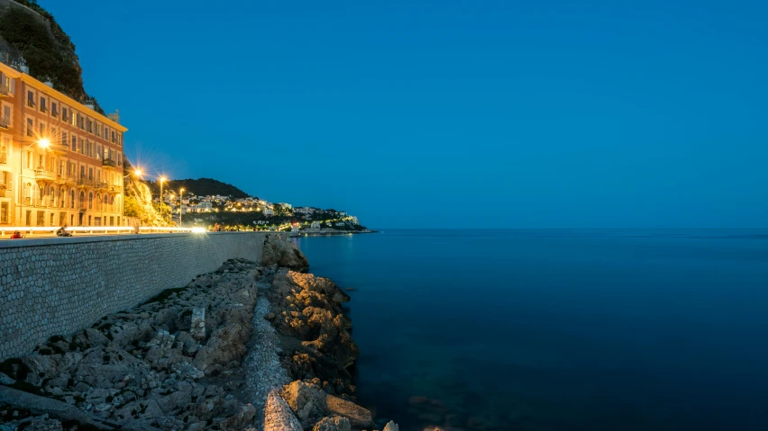 a city with sea and the street at night