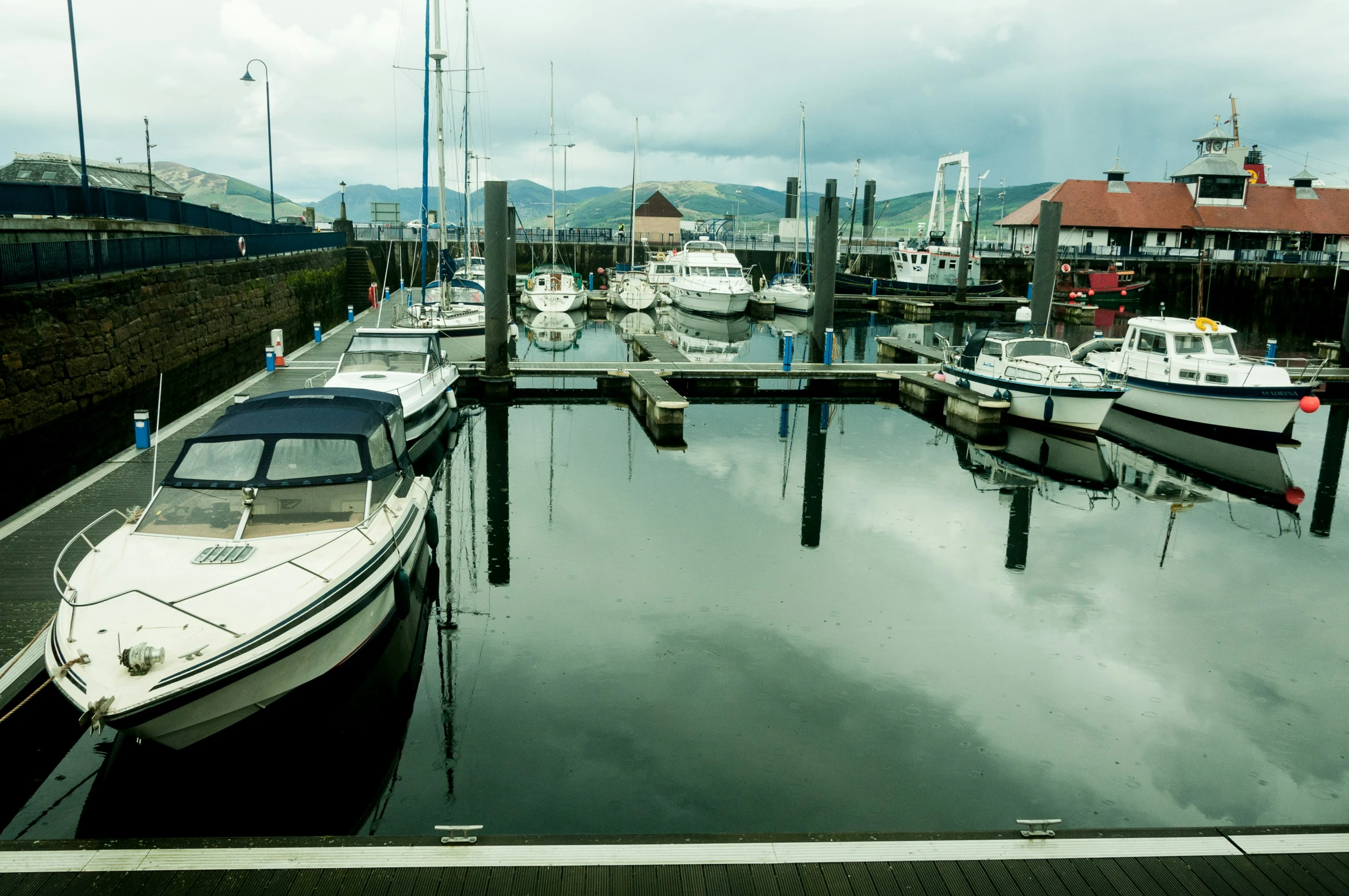 many boats are parked at the dock in this marina