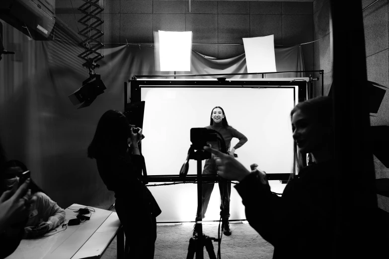 black and white pograph of woman getting a picture taken