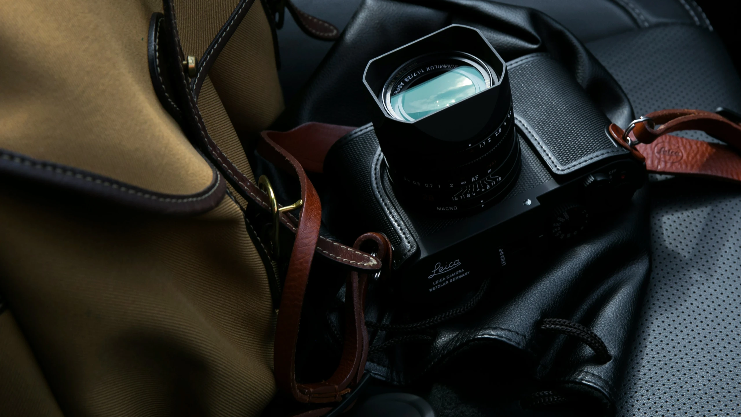 a camera and some luggage on a bench