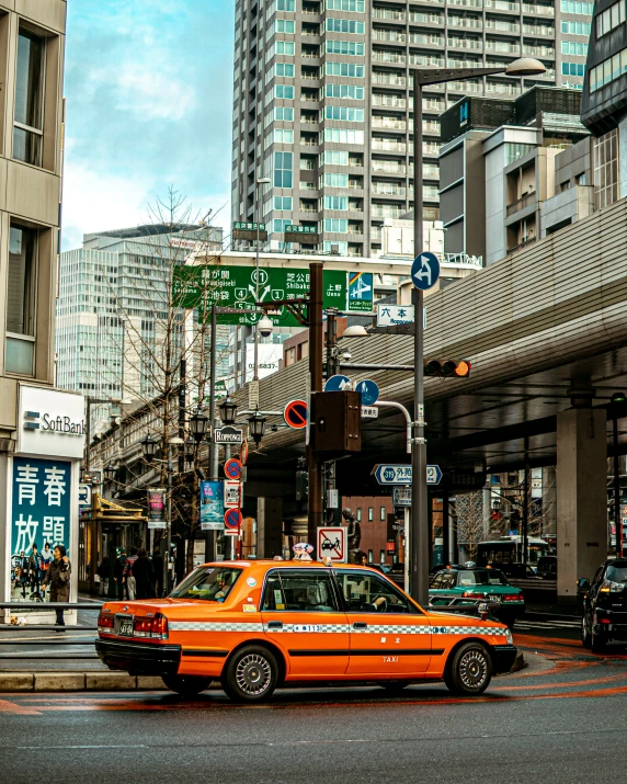 a taxi cab is stopped at an intersection