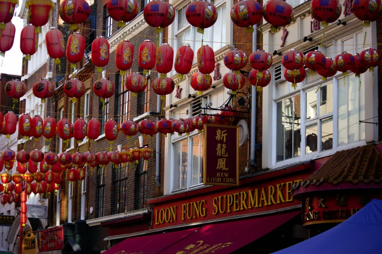 lanterns are hung on the side of a building