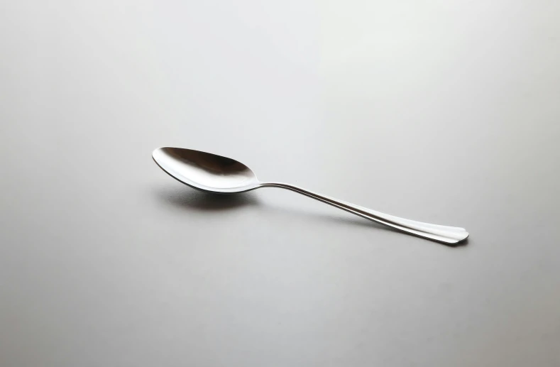 a spoon is sitting on top of a gray surface