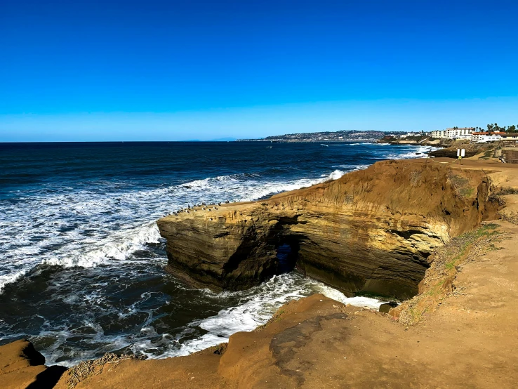 this is a small hole in the sand along the shore