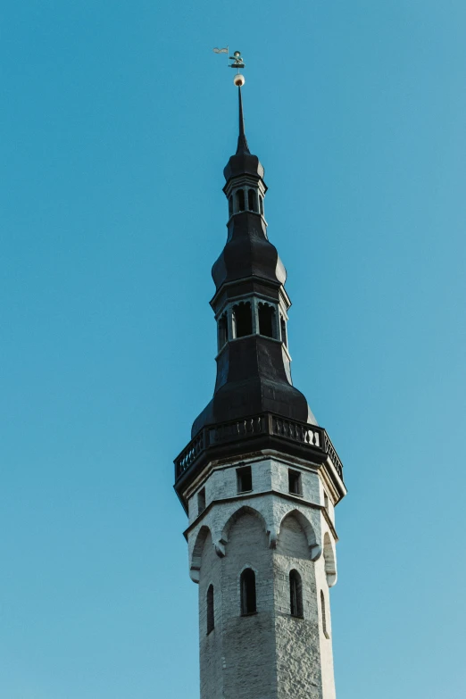 a large tower that has a cross on top of it