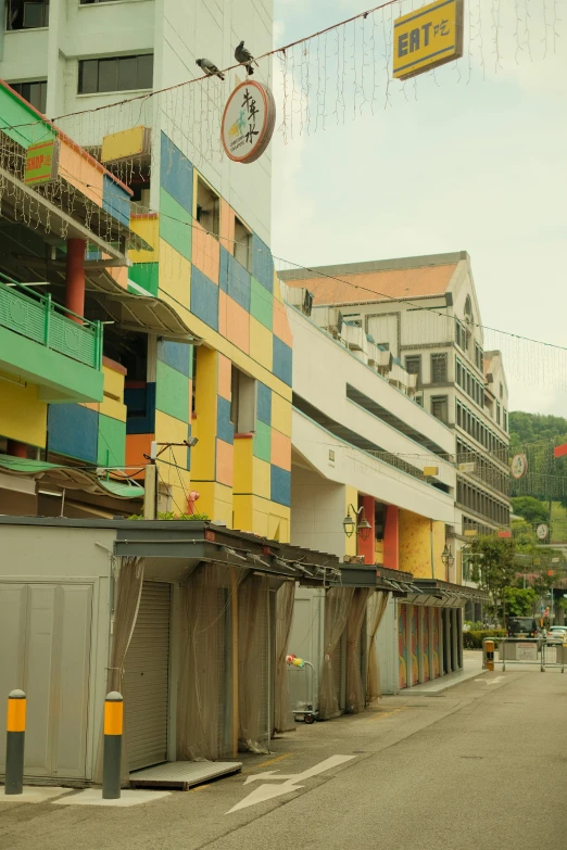 a city street scene with the street and buildings covered in colorful panels