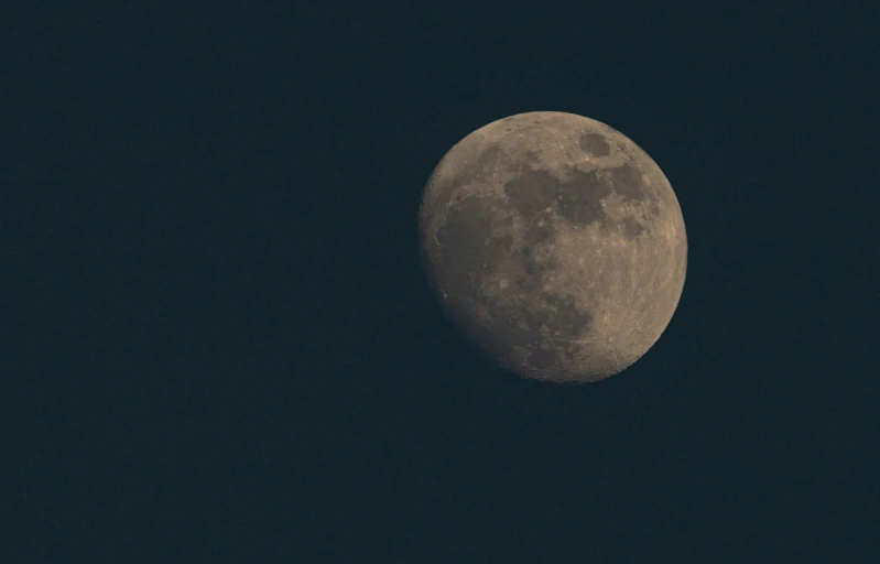 the full moon is visible as it moves through the night sky