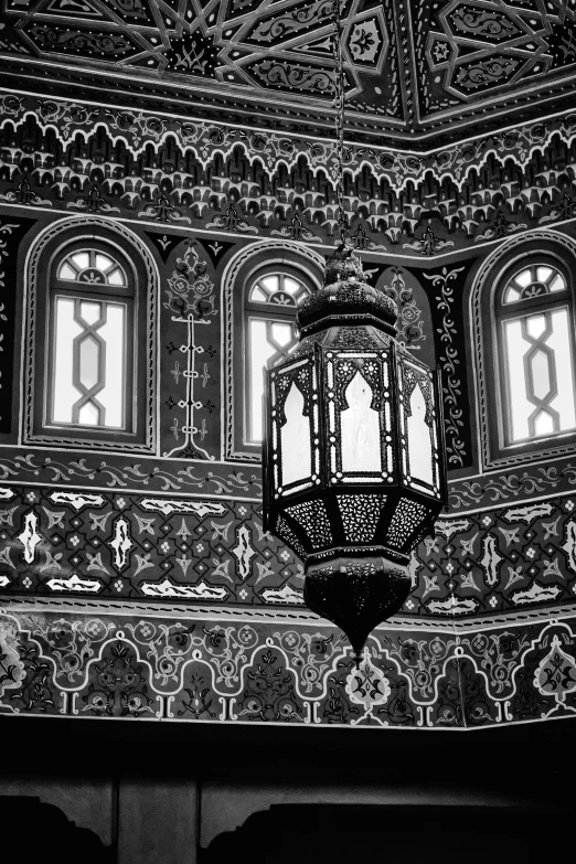 an ornate light hanging from the ceiling of a building