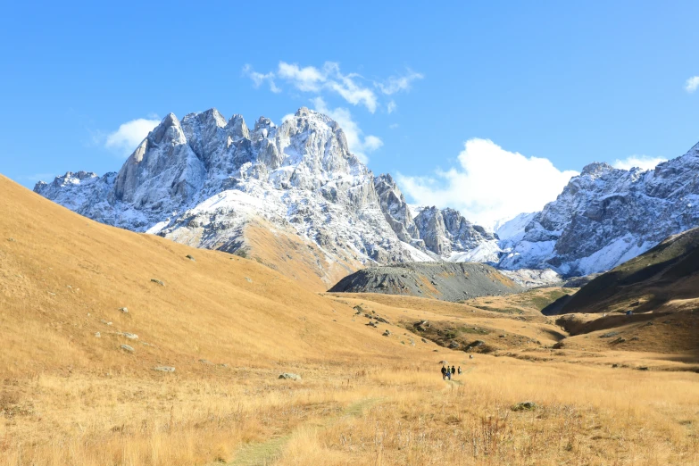 people trekking up the side of a mountain