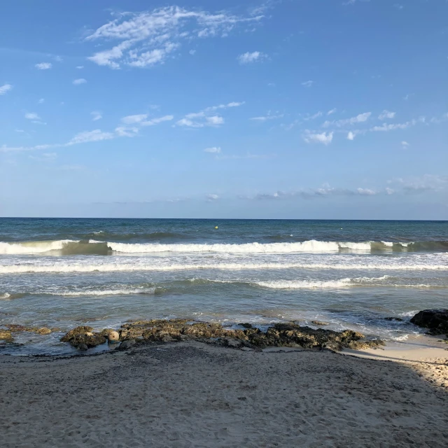 an ocean view from the beach in front of some waves