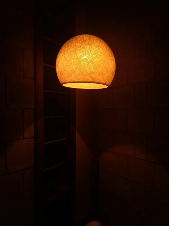 a floor lamp sitting on top of a brick floor