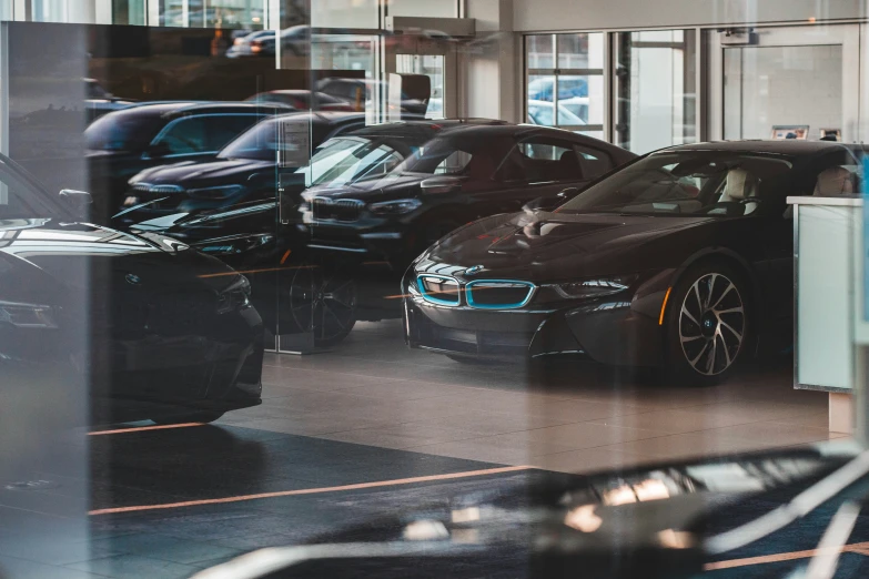 cars parked in parking garage with large glass window