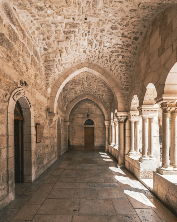 a long hallway with several large stone pillars