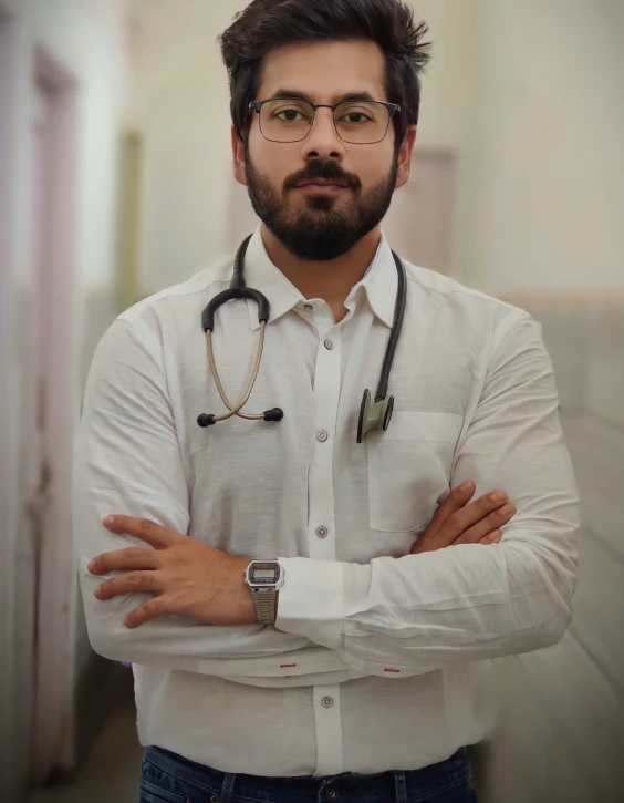 a man with glasses is standing in a hallway